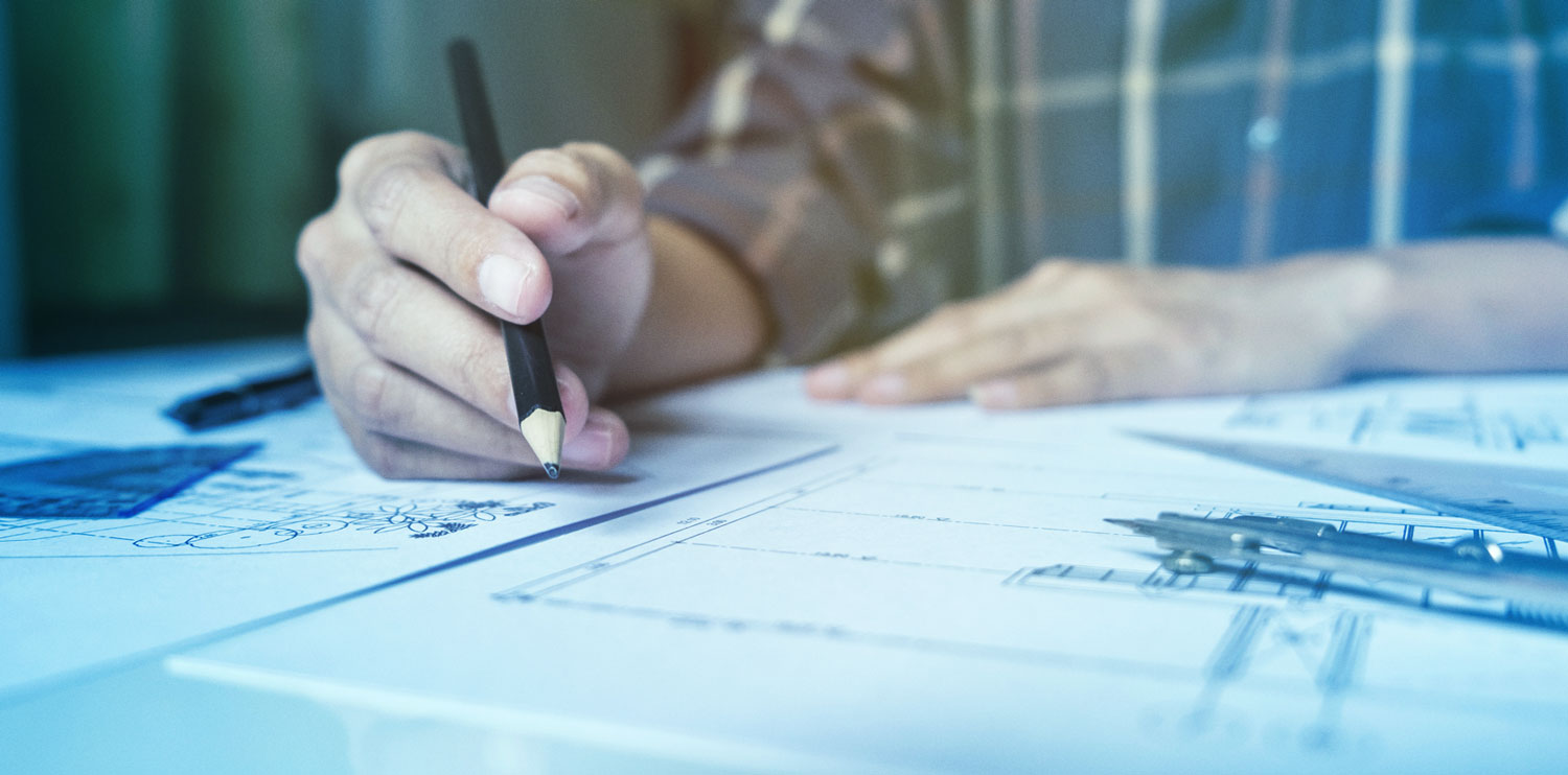 man at drafting table with blueprints